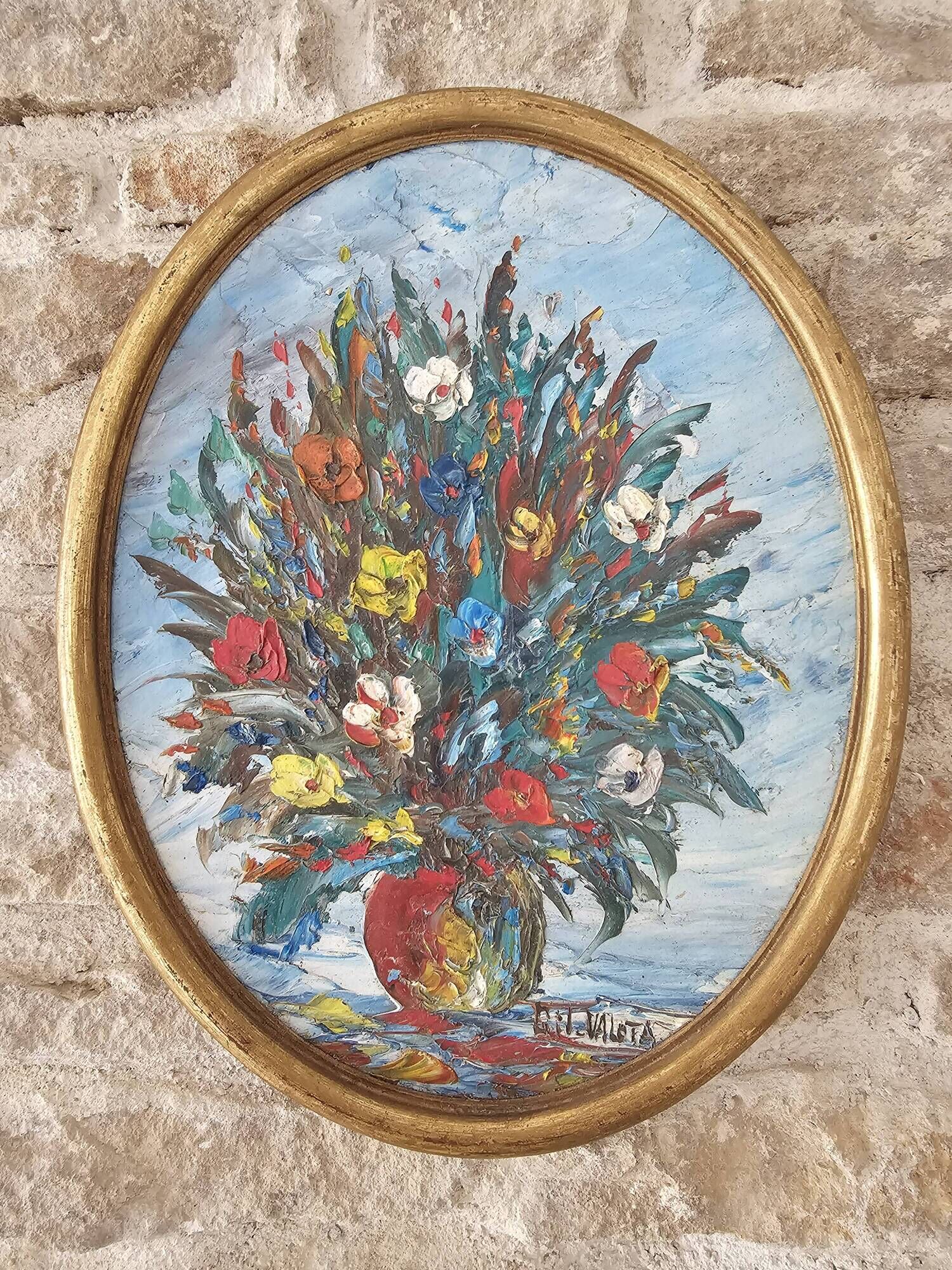 Oil painting on panel of a bouquet of colourful flowers in a vase, signed Valota.