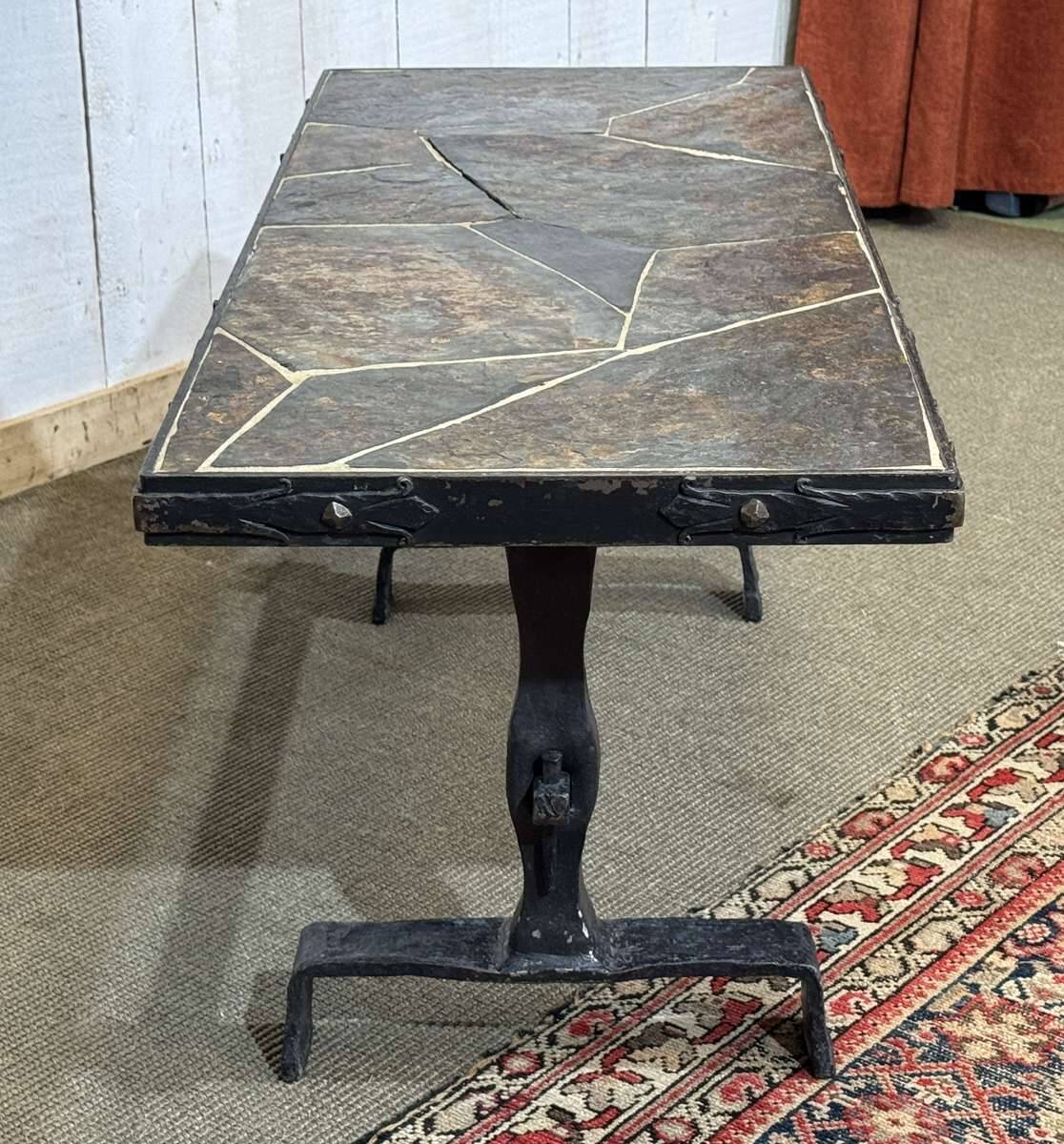 Coffee table in wrought iron with a slate top, work from the 1950s.