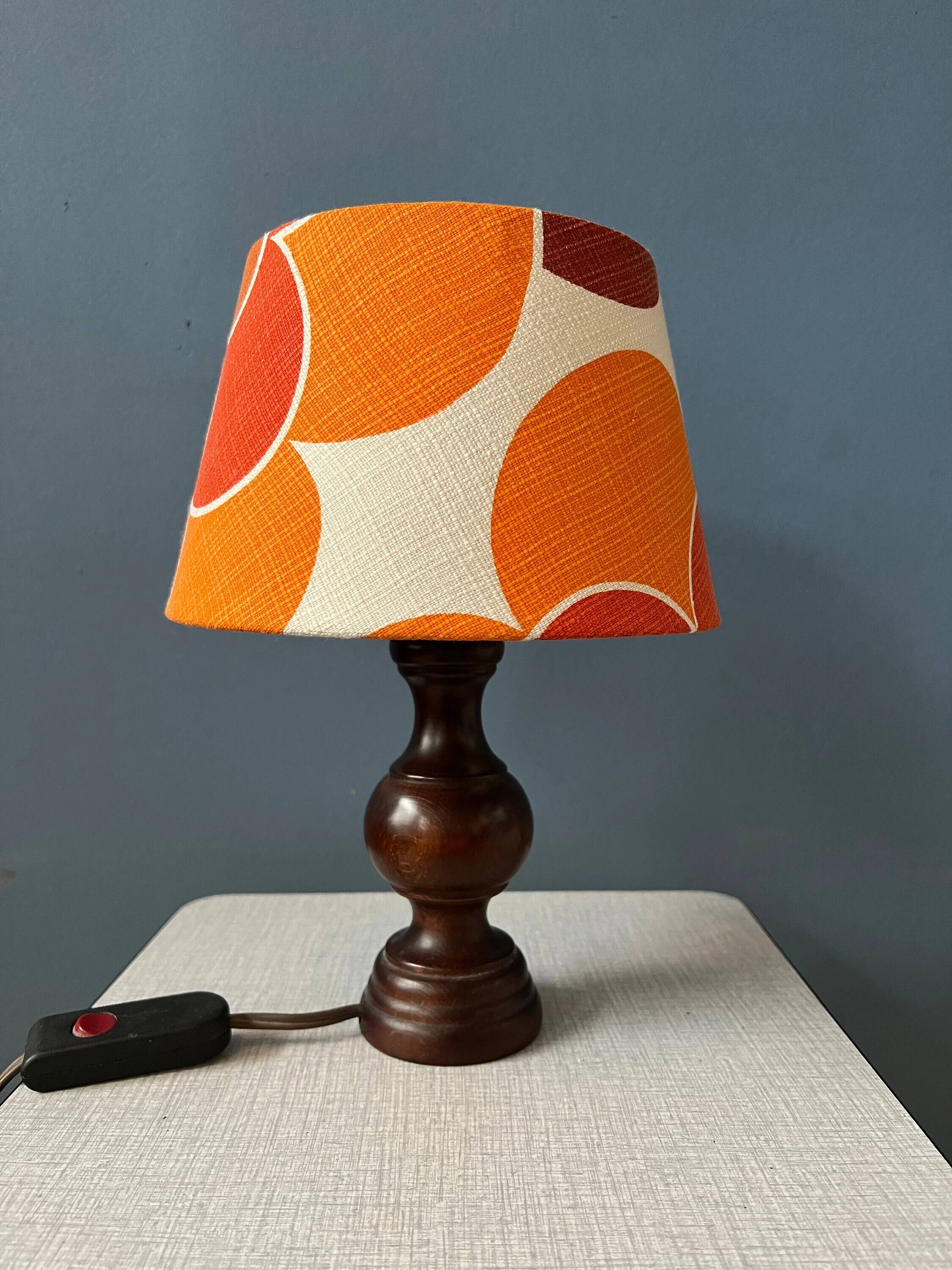 Vintage Space Age table lamp with orange fabric shade.