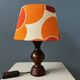 Vintage Space Age table lamp with orange fabric shade.