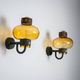 Pair of brass wall lamps with decorated amber coloured shades