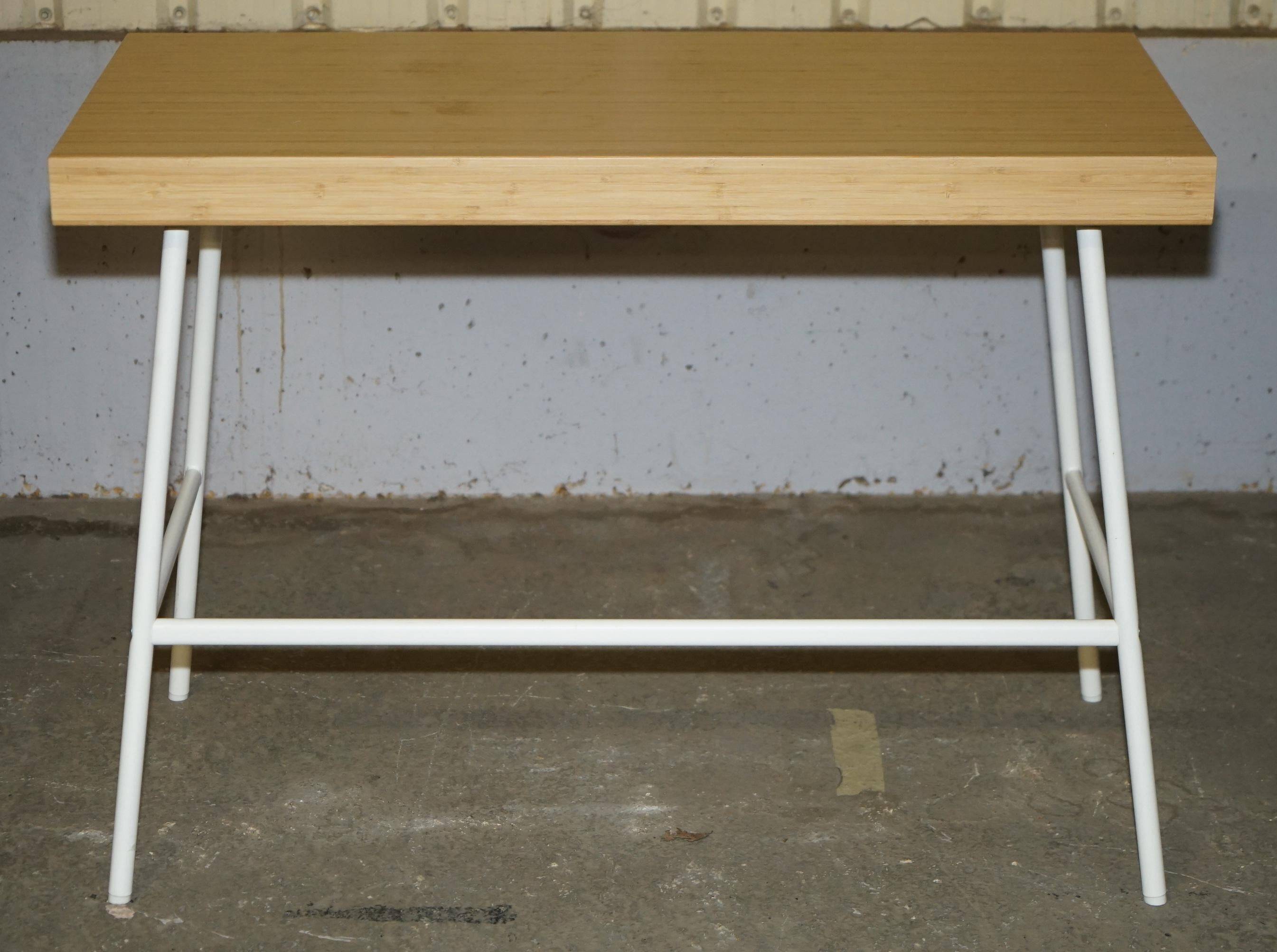 Small bamboo desk with three drawers.