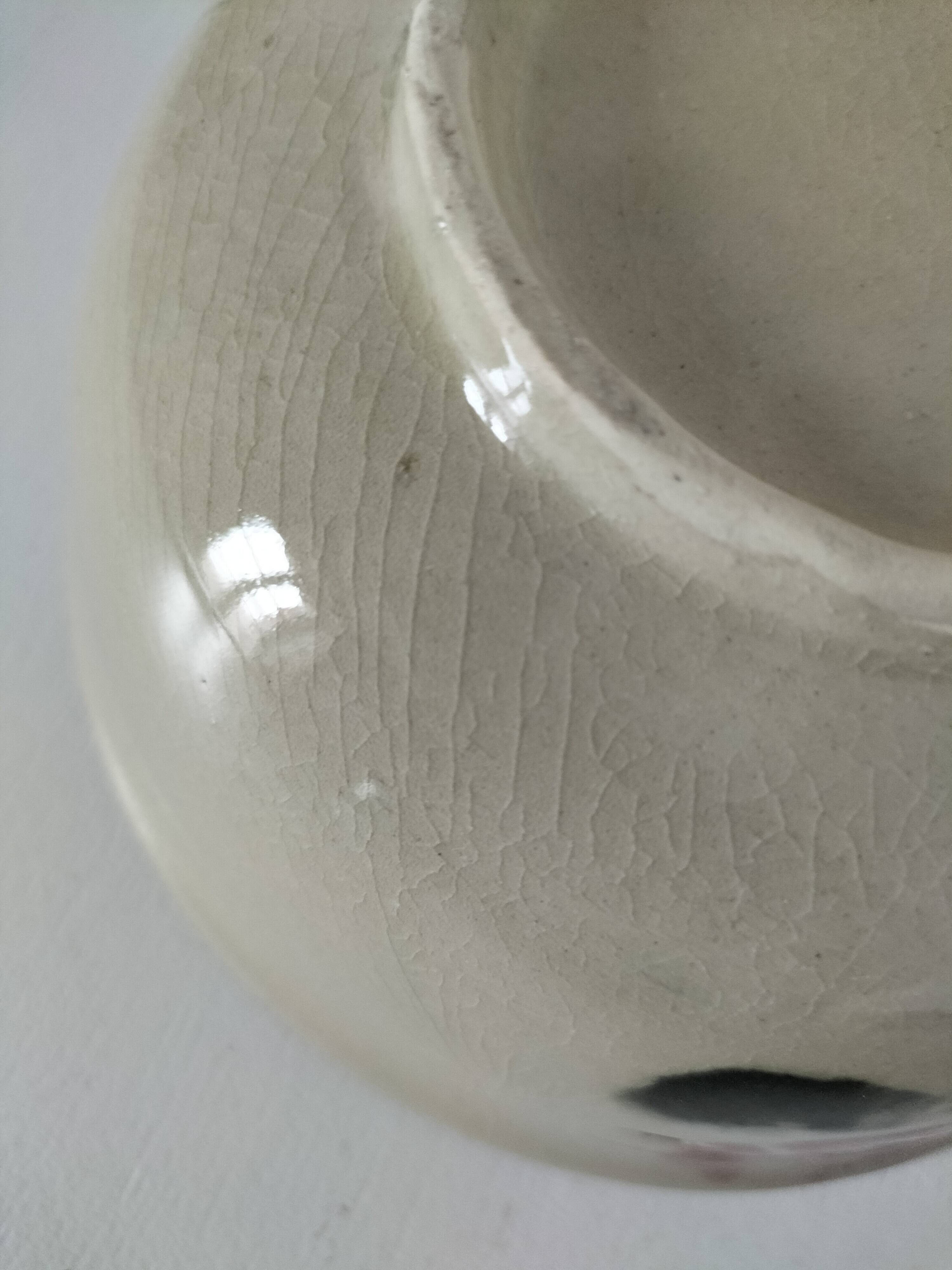 Two large vintage bowls in pastel decor on mini pedestals.