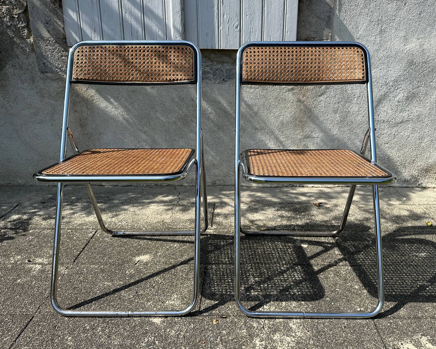 Pair of vintage metal caned folding chairs