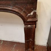 Pair of Louis XIV style fireplaces in red cherry marble. XIX century.