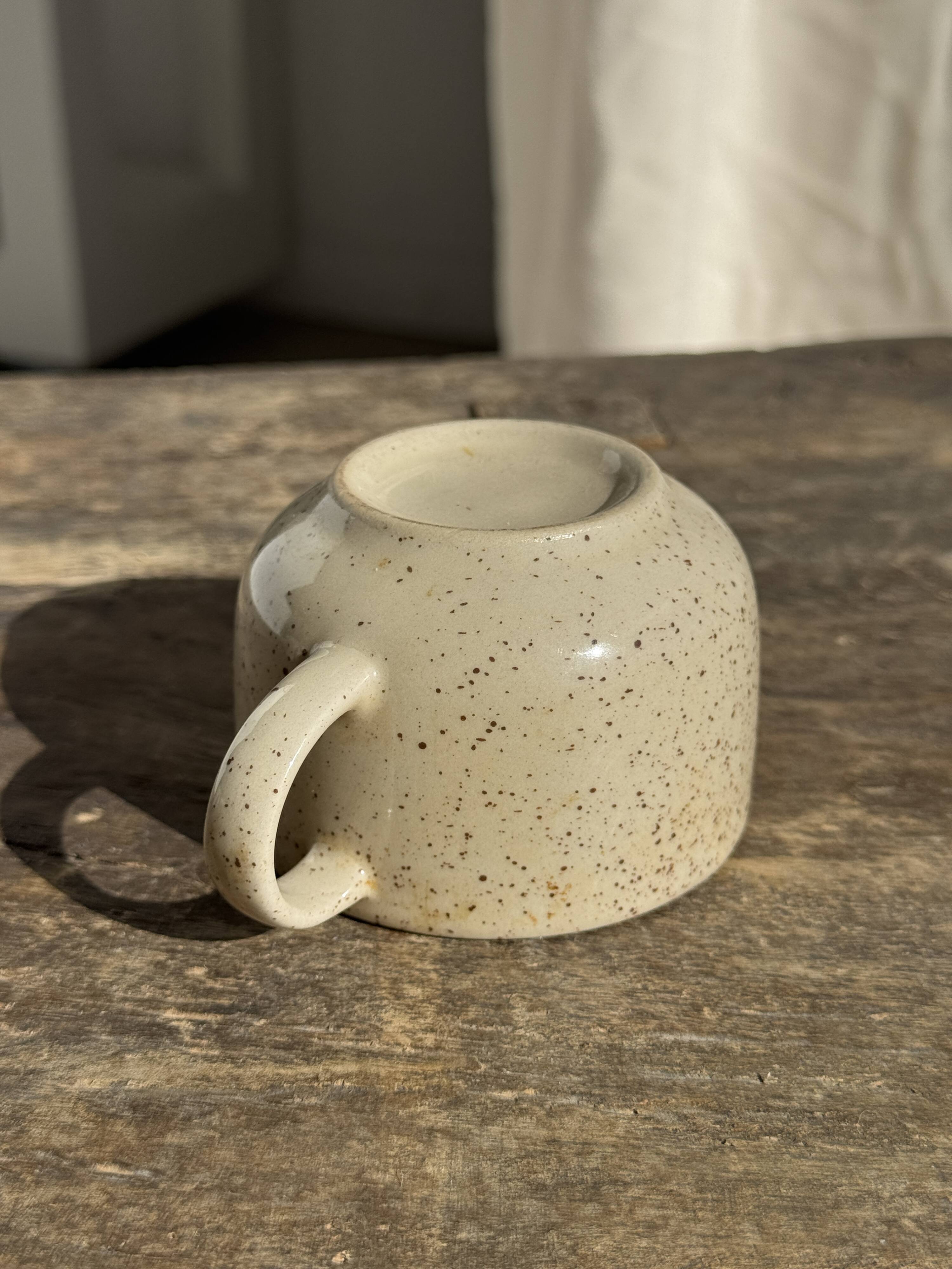 Set of 4 vintage speckled beige stoneware coffee cups.