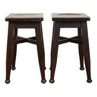 Set of 2 antique English solid oak stools with a touch of art nouveau style.