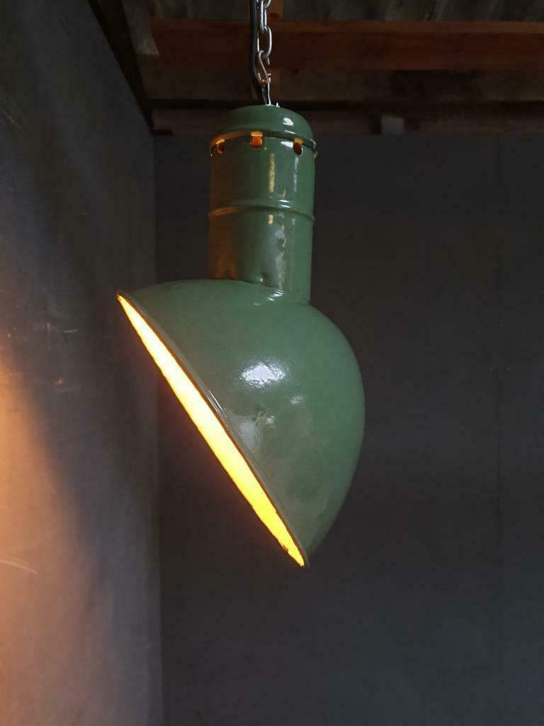 Old industrial enamel lamp in green