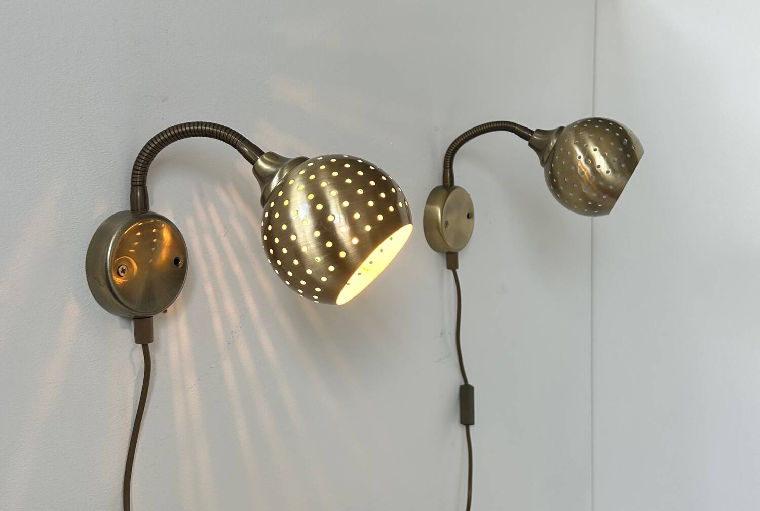 Pair of vintage adjustable wall lights, perforated brass, Sweden 1960