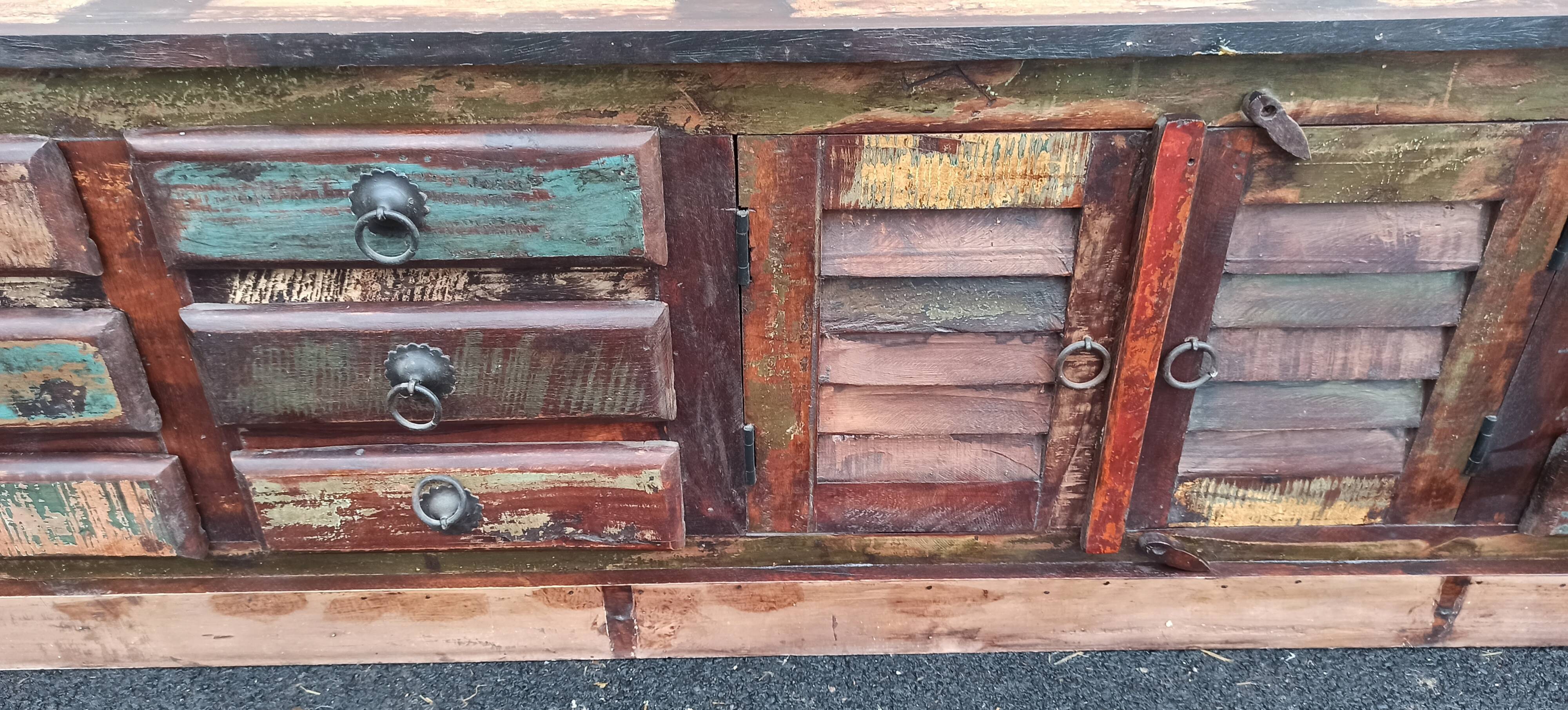 Furniture low in colorful wood. 12 drawers and 1 door