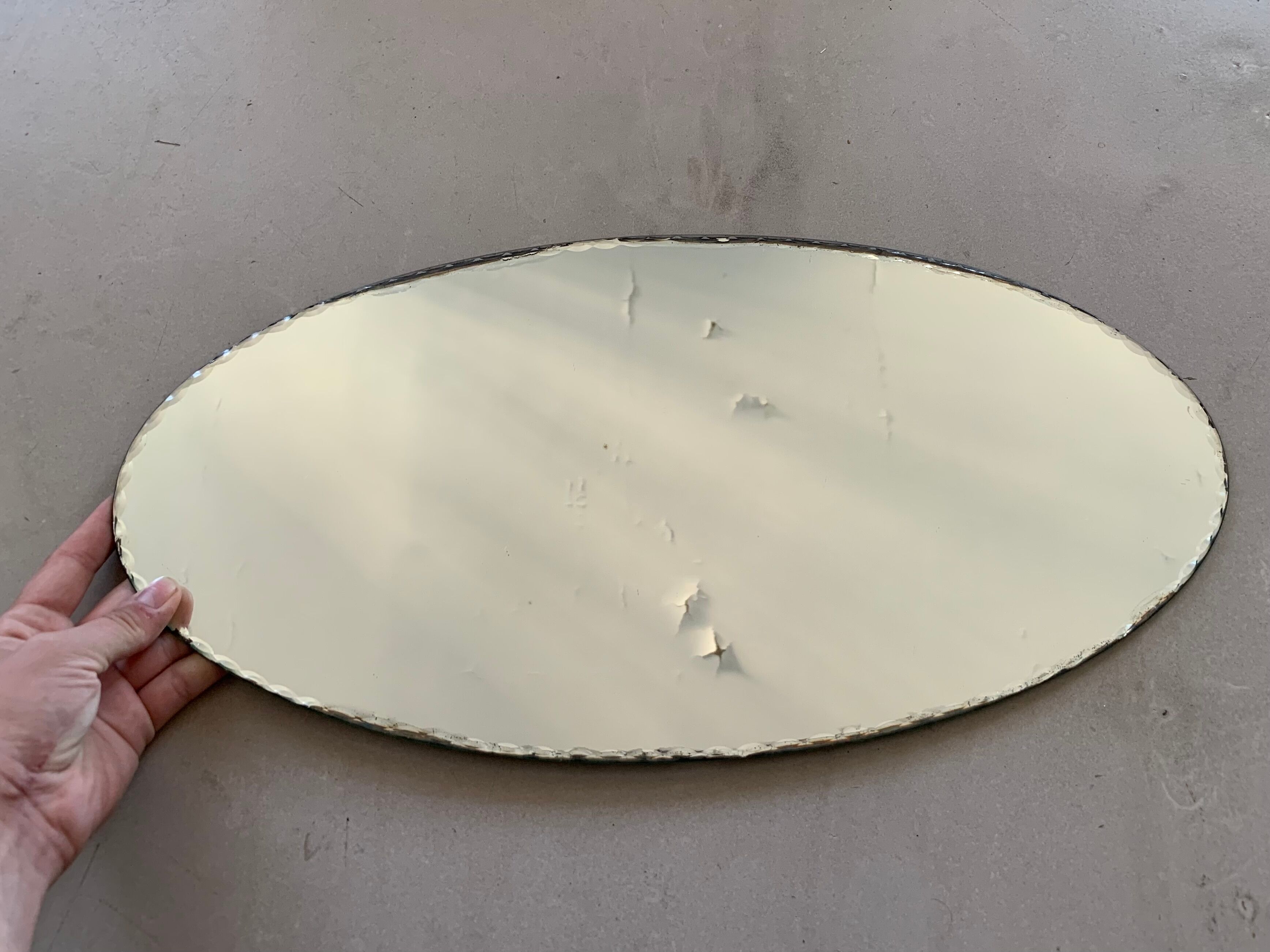 Old beveled oval mirror