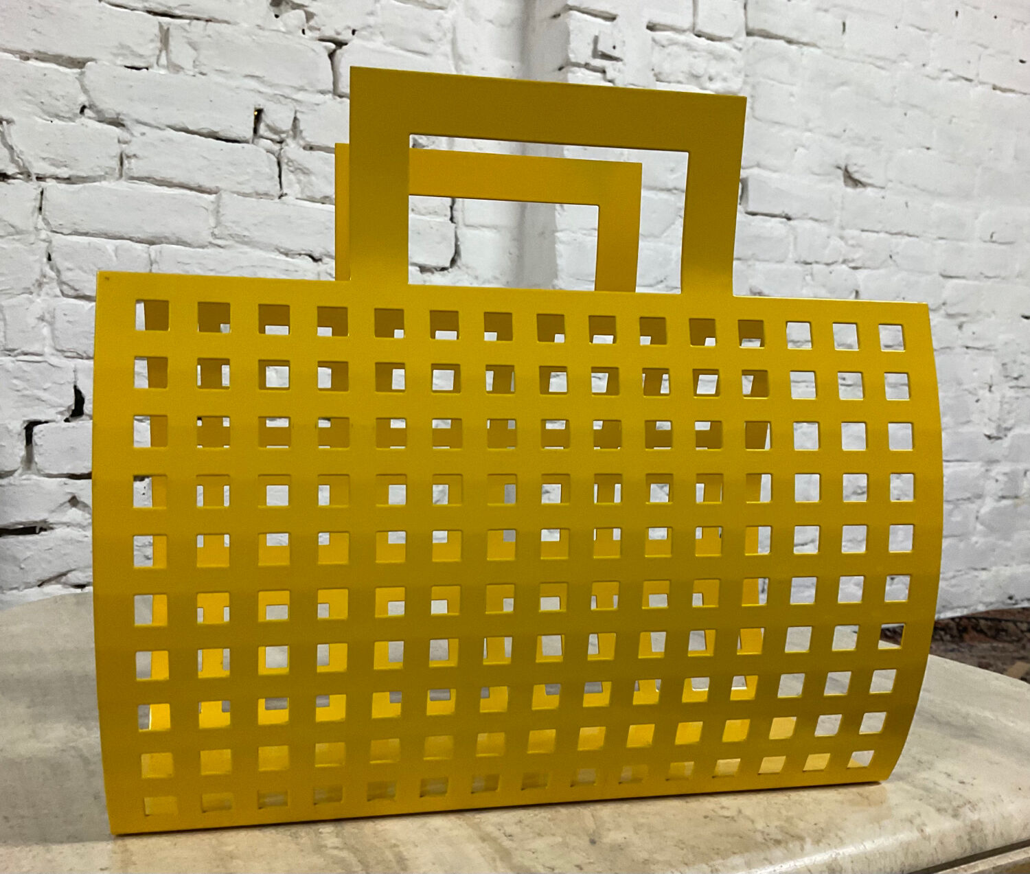 Vintage magazine rack in yellow metal
