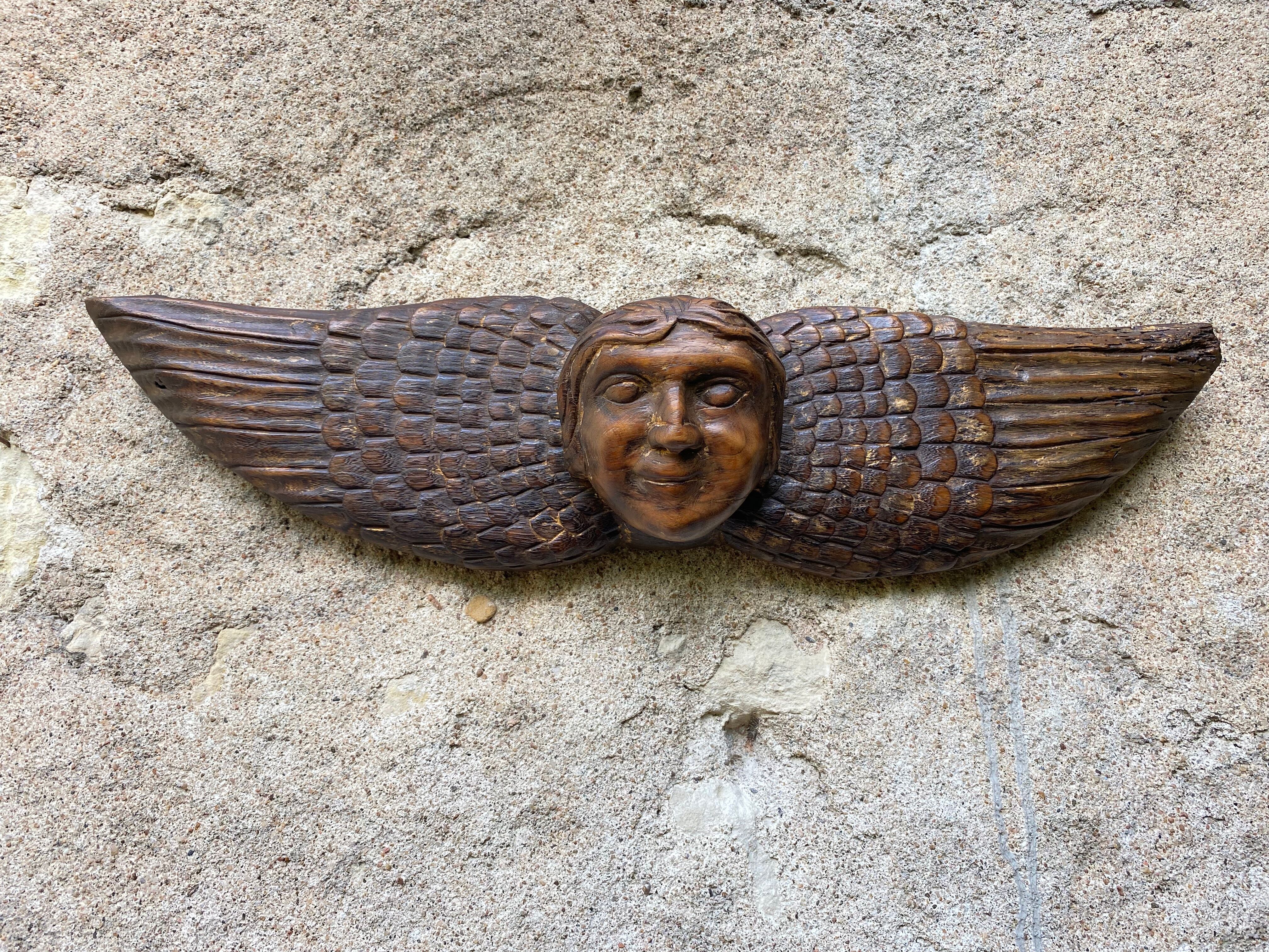 Carved wooden angel head