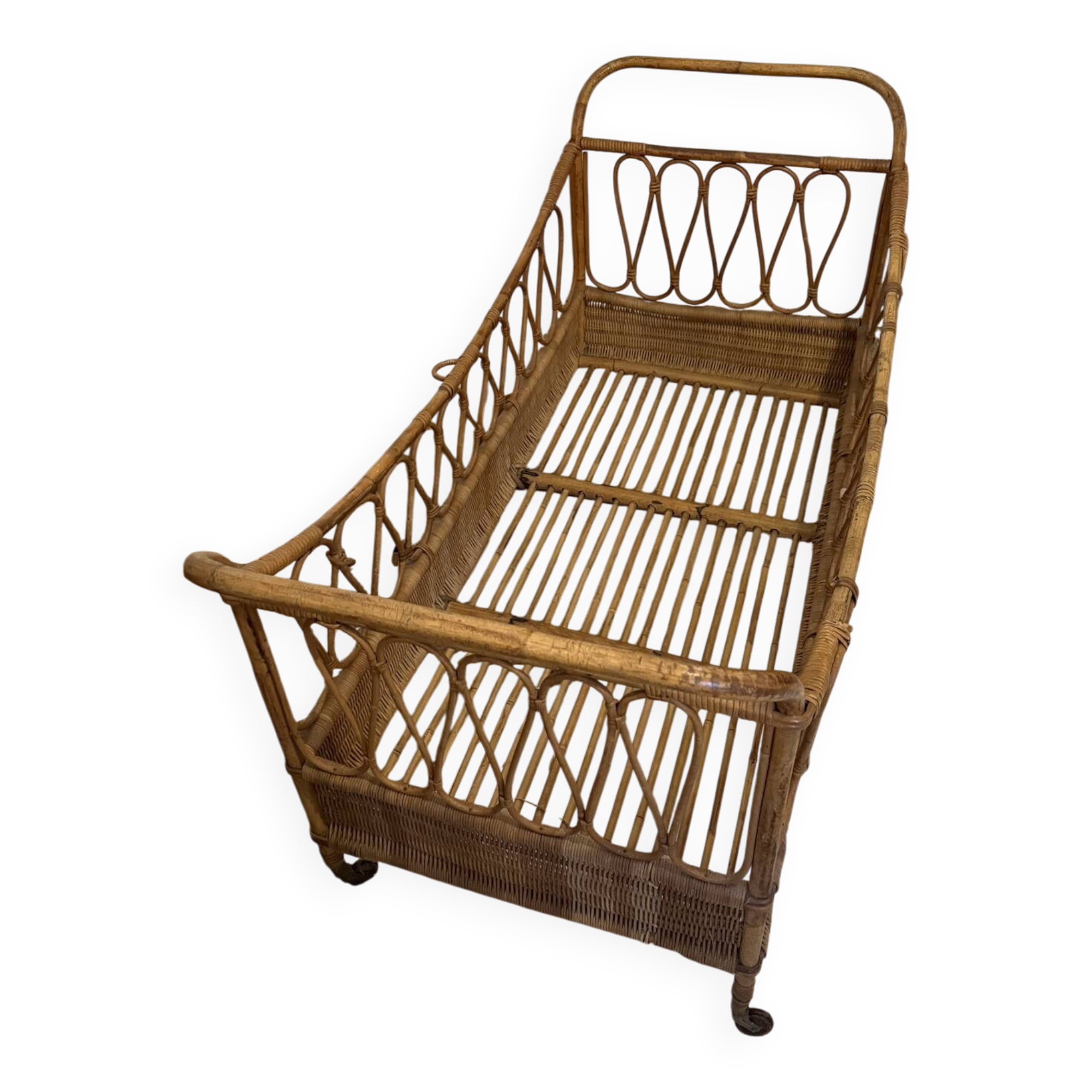 Vintage rattan baby cot on wheels.