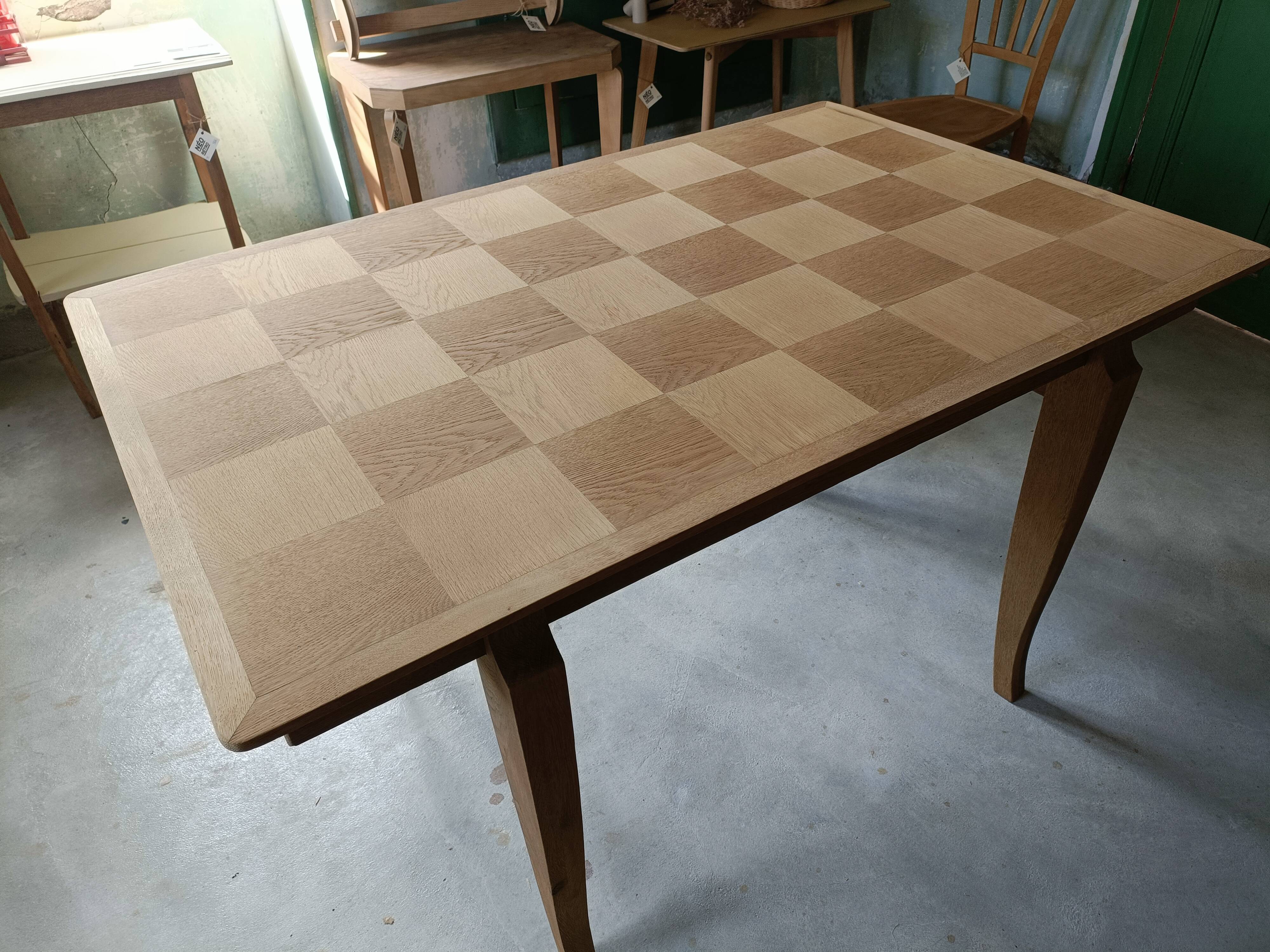 Oak dining table with a checkerboard top and extensions.