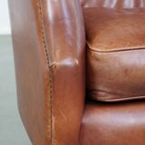 Cowhide armchair in good condition, finished with decorative nails