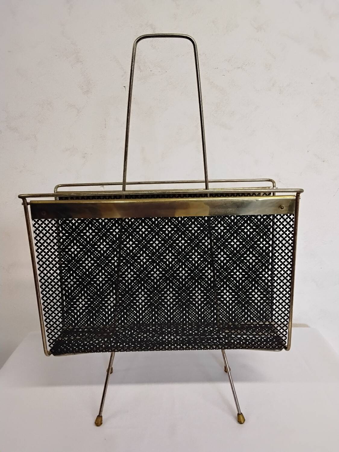 Vintage gold magazine rack from the 1960s.