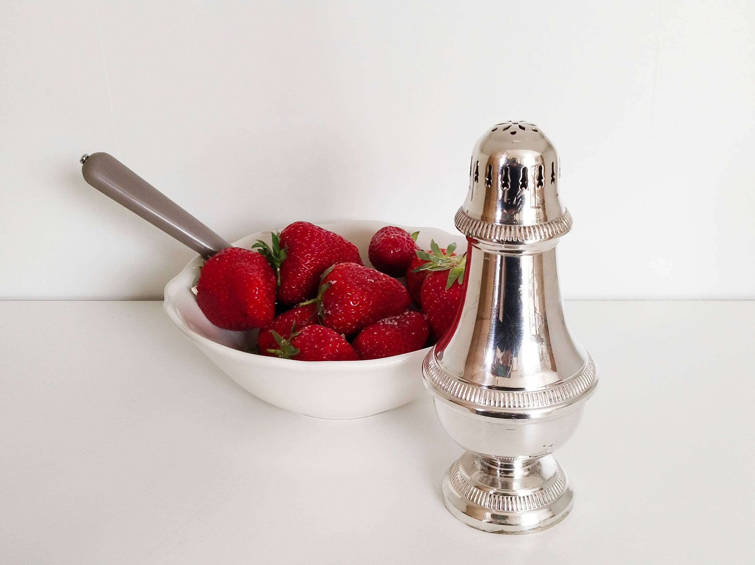 Silver-plated sugar shaker with fluted edges