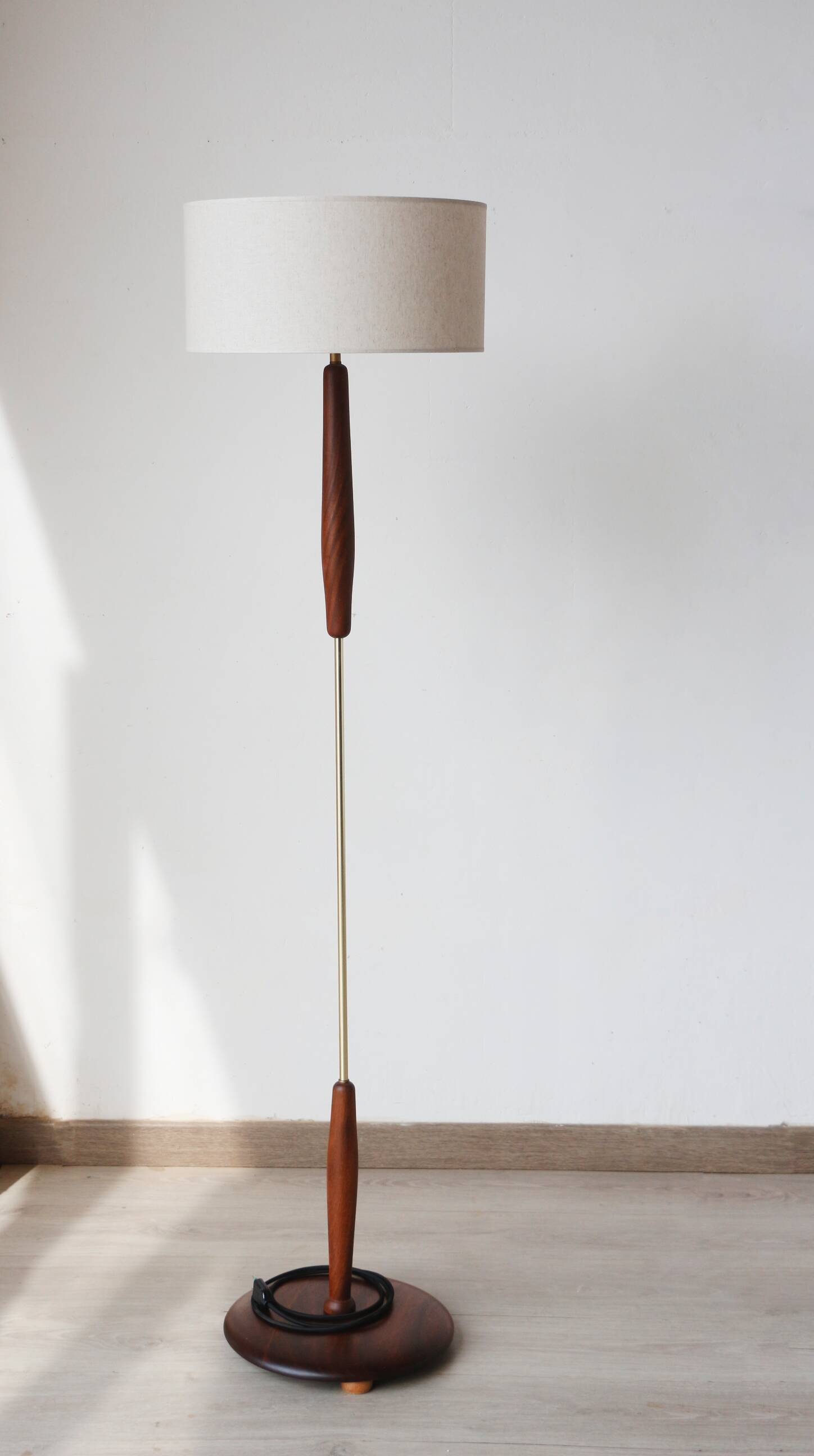 Vintage floor lamp in teak and brass with a cream shade.