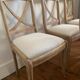Set of 6 cross-back chairs in solid wood, with white boucle seats.