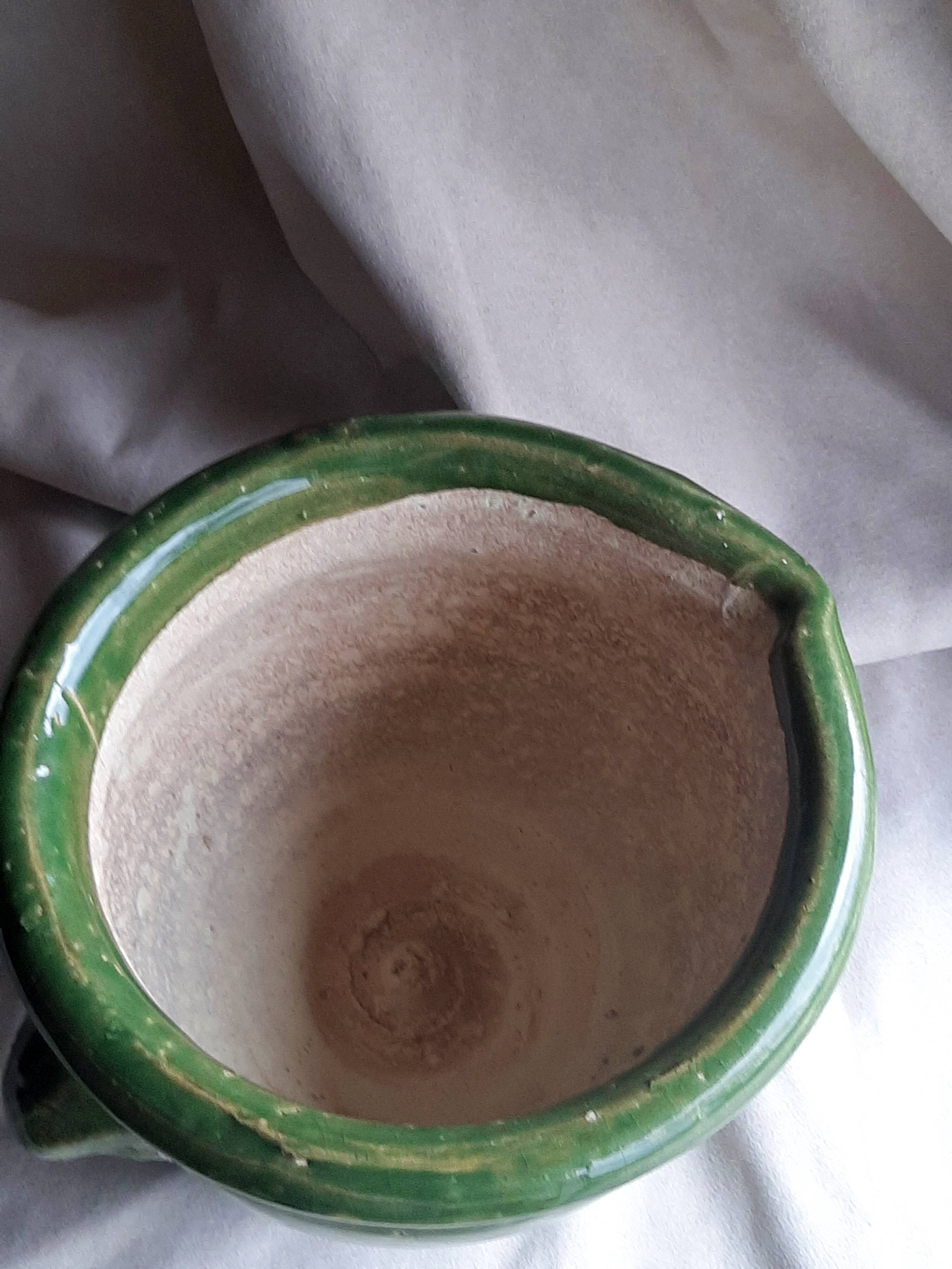 Glazed green terracotta pot.