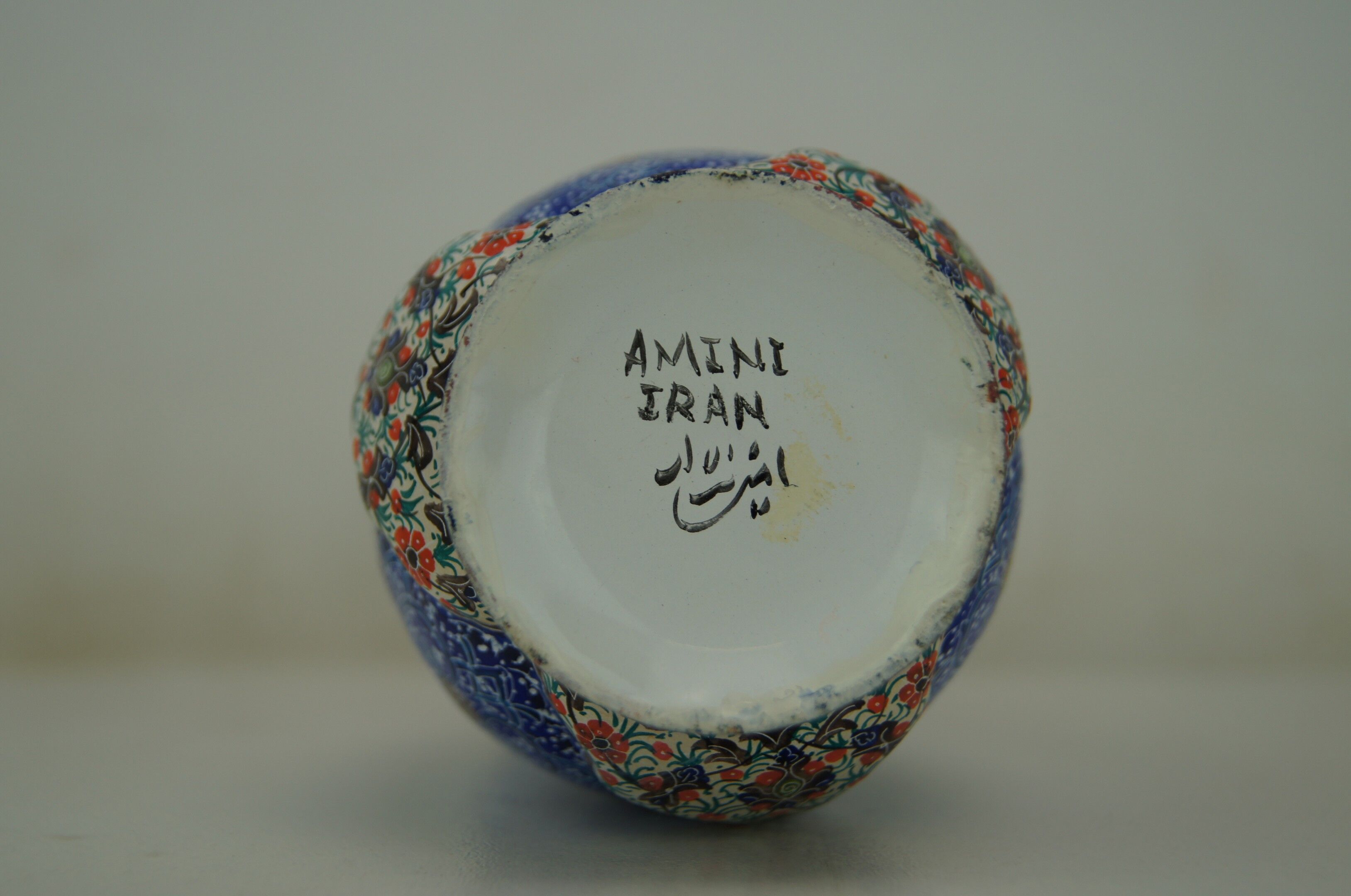 Piriform vase with a flared metal collar enamelled with a polychrome decoration, marked "Amini Iran" on the reverse.