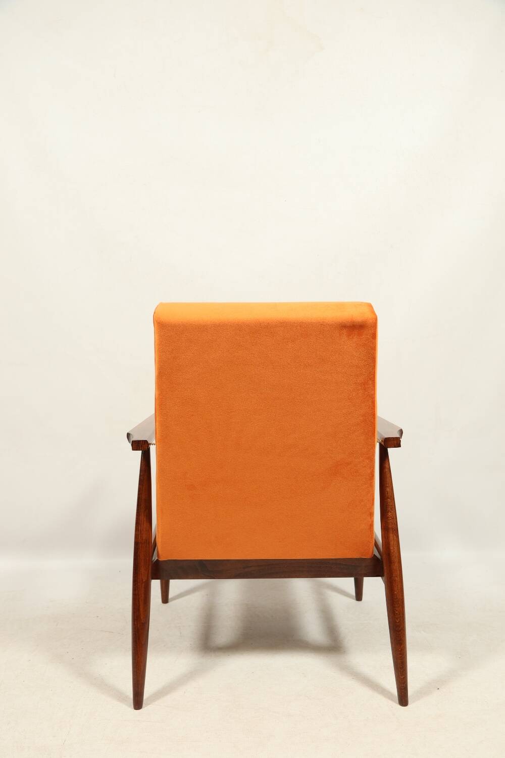 Modern armchair in orange papaya velvet with dark brown wood, 1970s Scandinavian style.