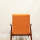 Modern armchair in orange papaya velvet with dark brown wood, 1970s Scandinavian style.