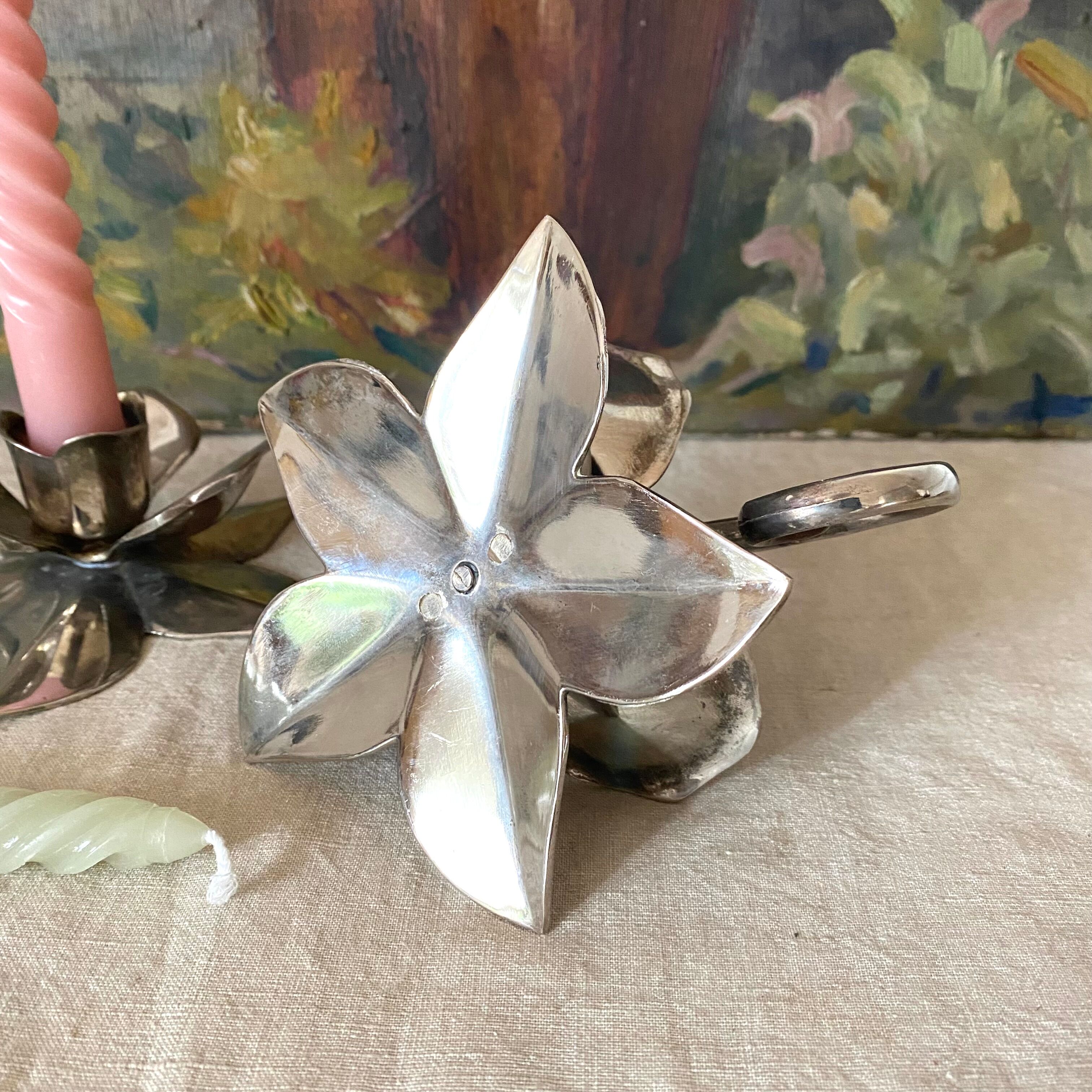 Pair of silver metal flower candle holders