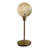 Table lamp with an antique golden streaked globe and a golden foot