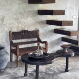 Small antique Indonesian bench in carved teak with plant and floral motifs.