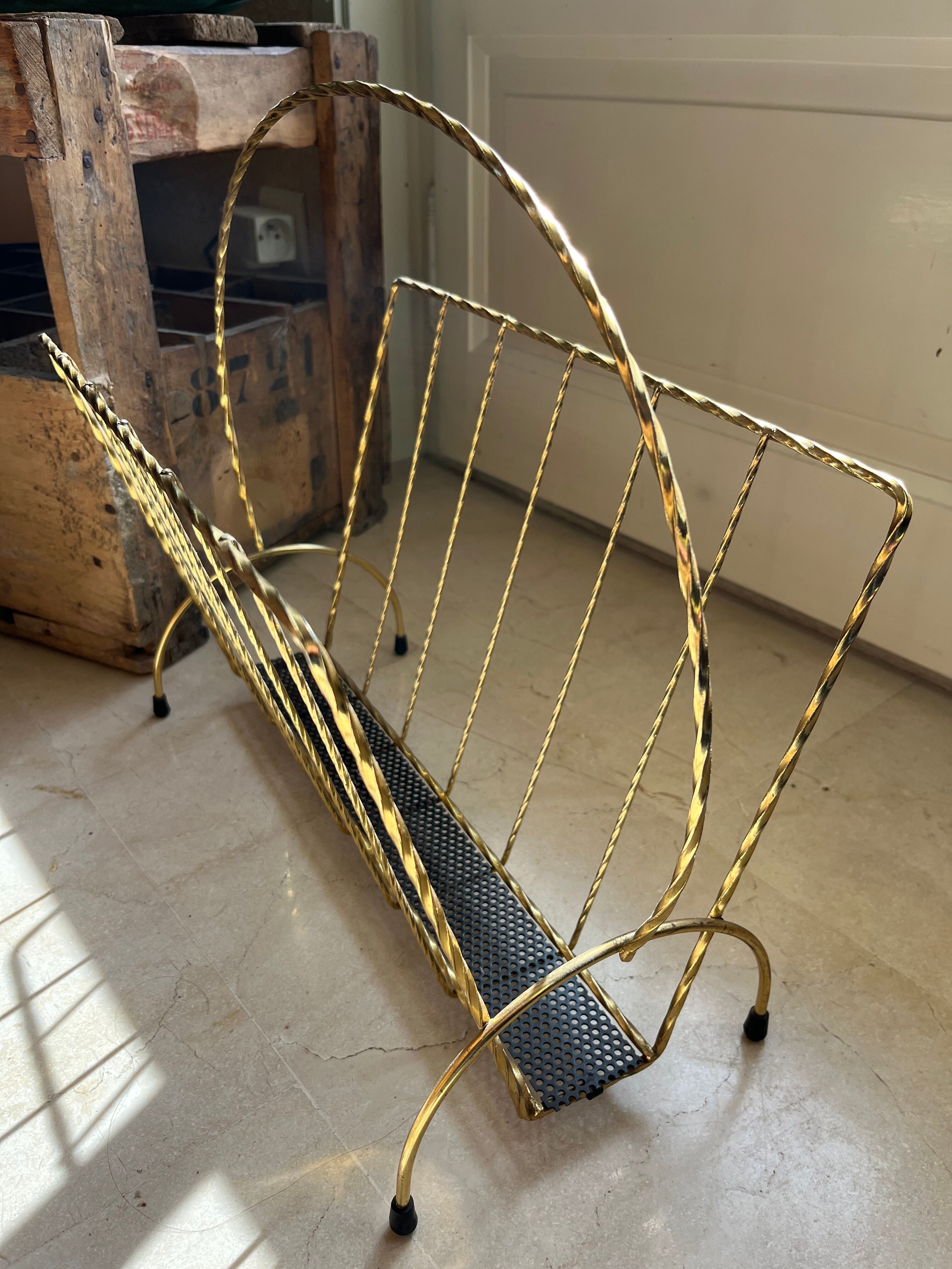 Vintage gold metal magazine rack from the 1960s.