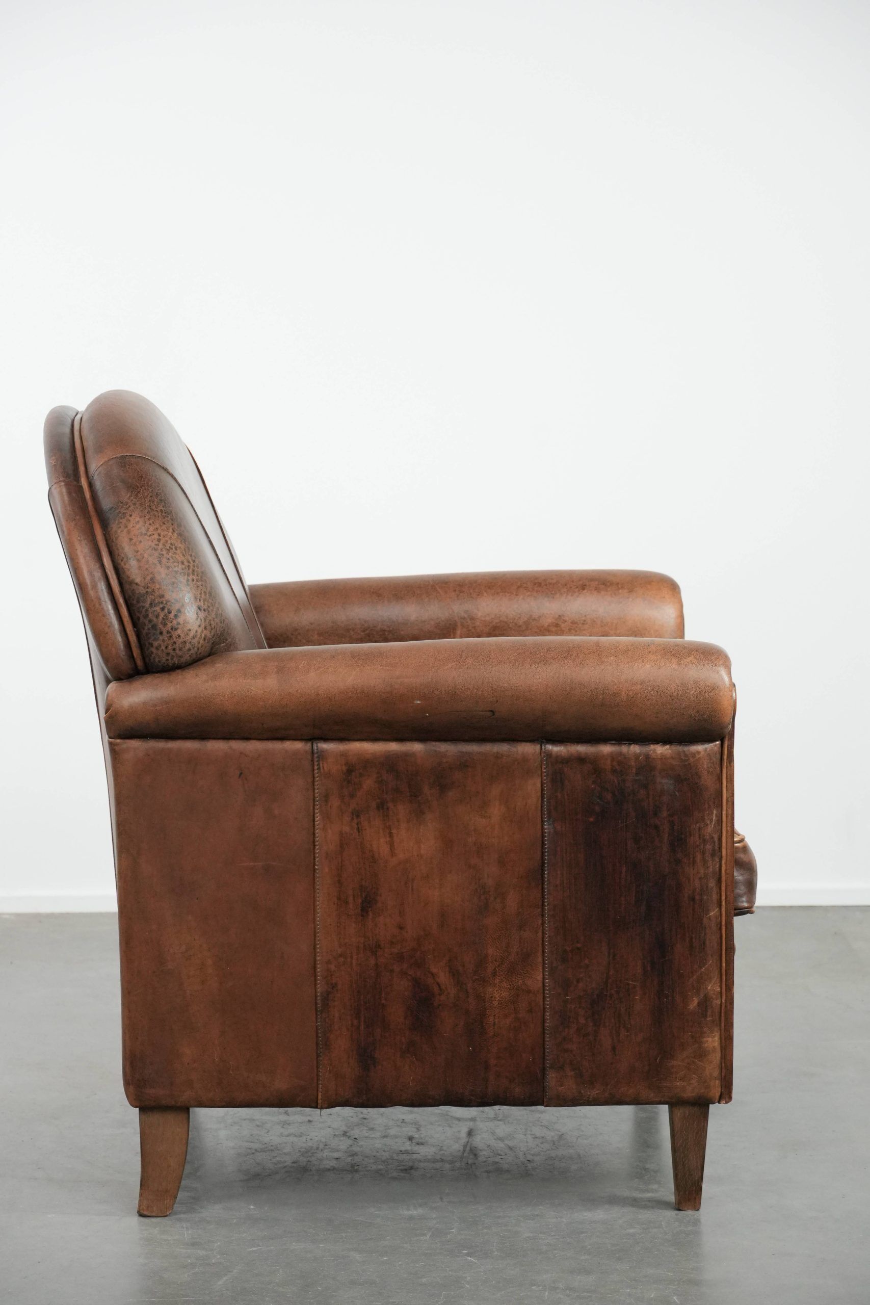 Vintage sheepskin armchair with warm colours and a characterful appearance