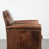Vintage sheepskin armchair with warm colours and a characterful appearance