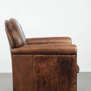 Vintage sheepskin armchair with warm colours and a characterful appearance