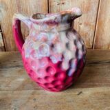 Old pitcher in burgundy ceramic