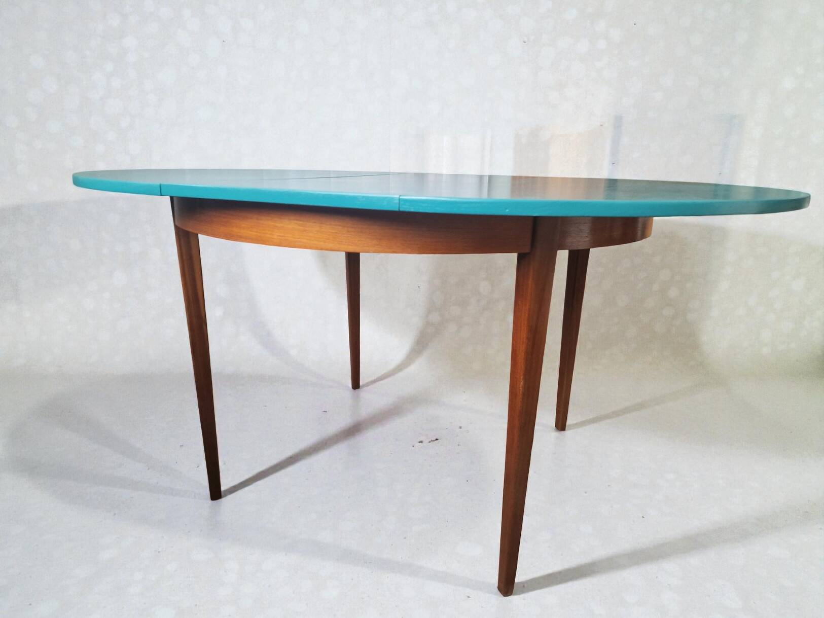 Extendable oval teak dining table