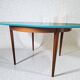 Extendable oval teak dining table