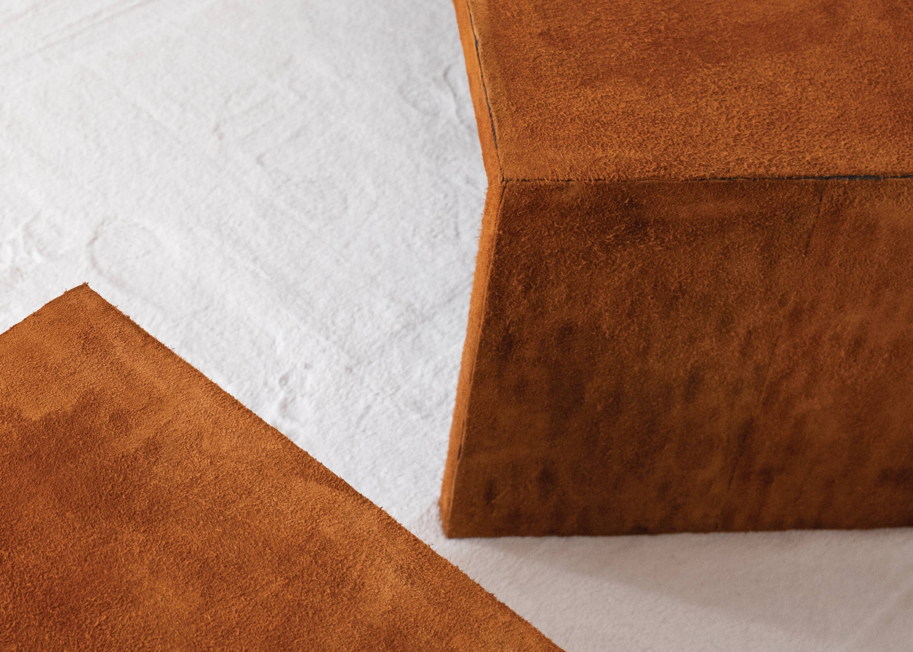 Pair of cognac suede side tables in the style of Jean Michel Frank.