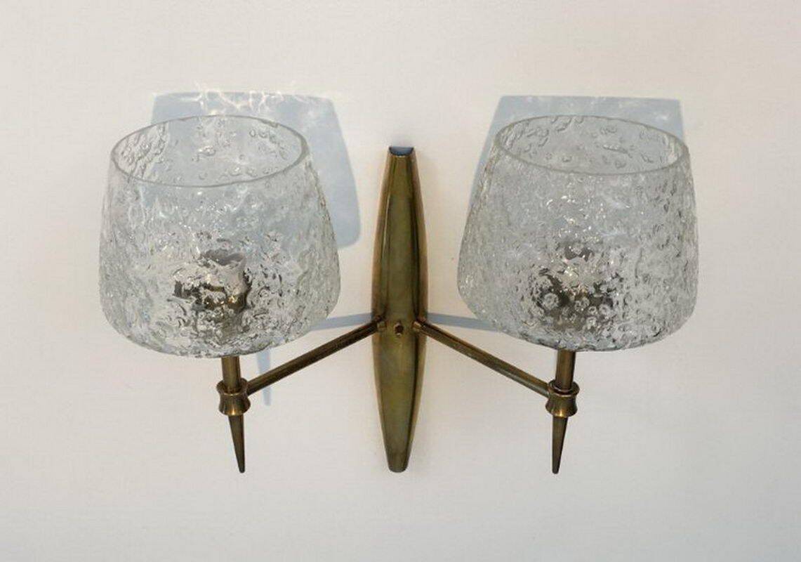 Pair of bronze wall sconces with worked glass reflectors. Stilnovo