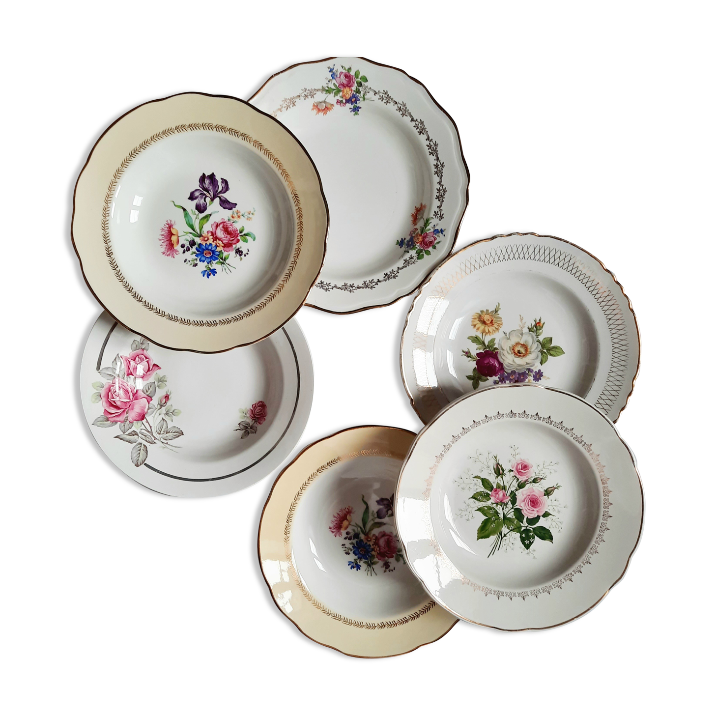 Old hollow plates mismatched in earthenware with gilded edges