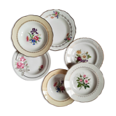 Old hollow plates mismatched in earthenware with gilded edges