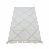 Small white Moroccan rug with diamond patterns