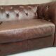 Three seater brown leather chesterfield sofa