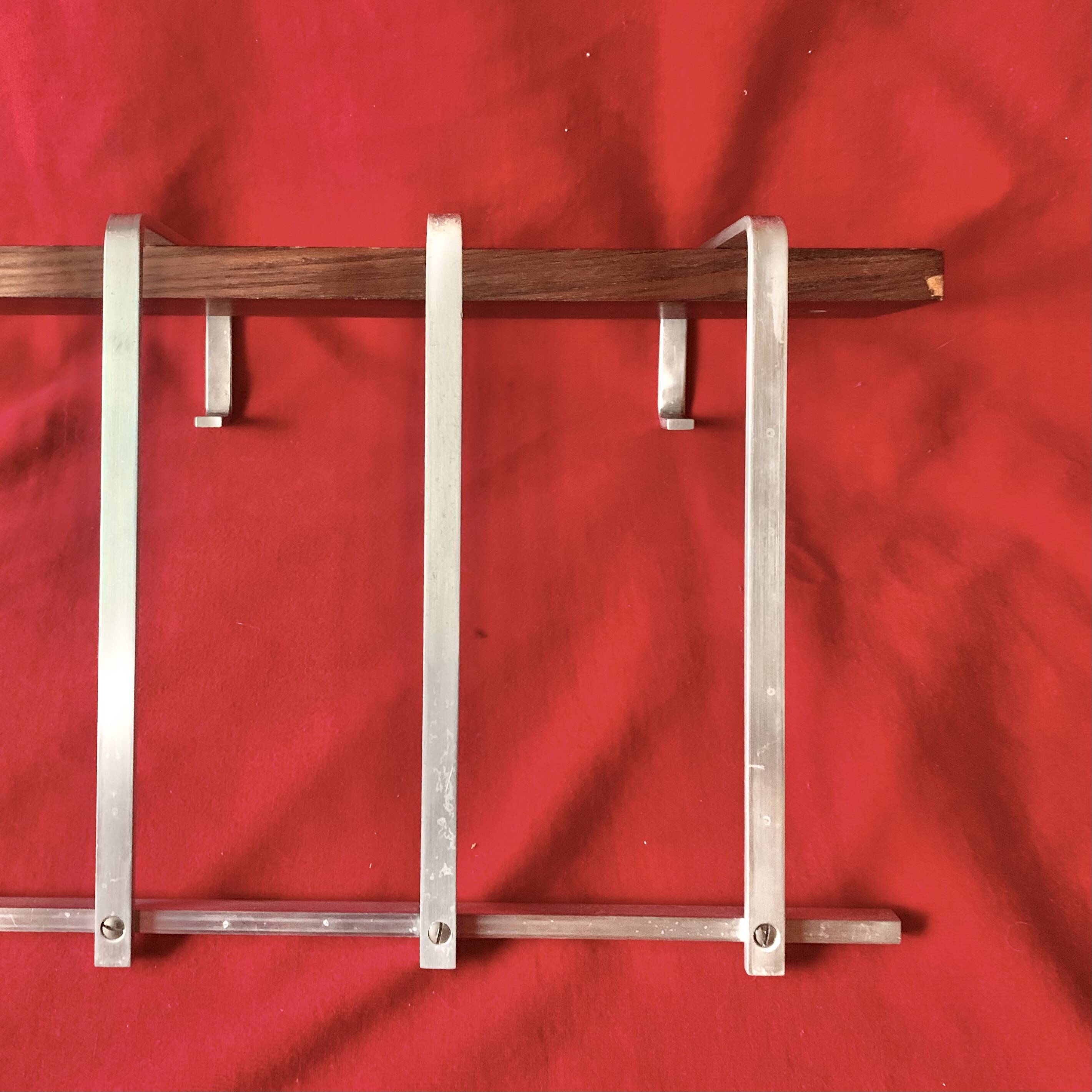 Vintage wall-mounted coat rack made of plywood and aluminum with hat rack