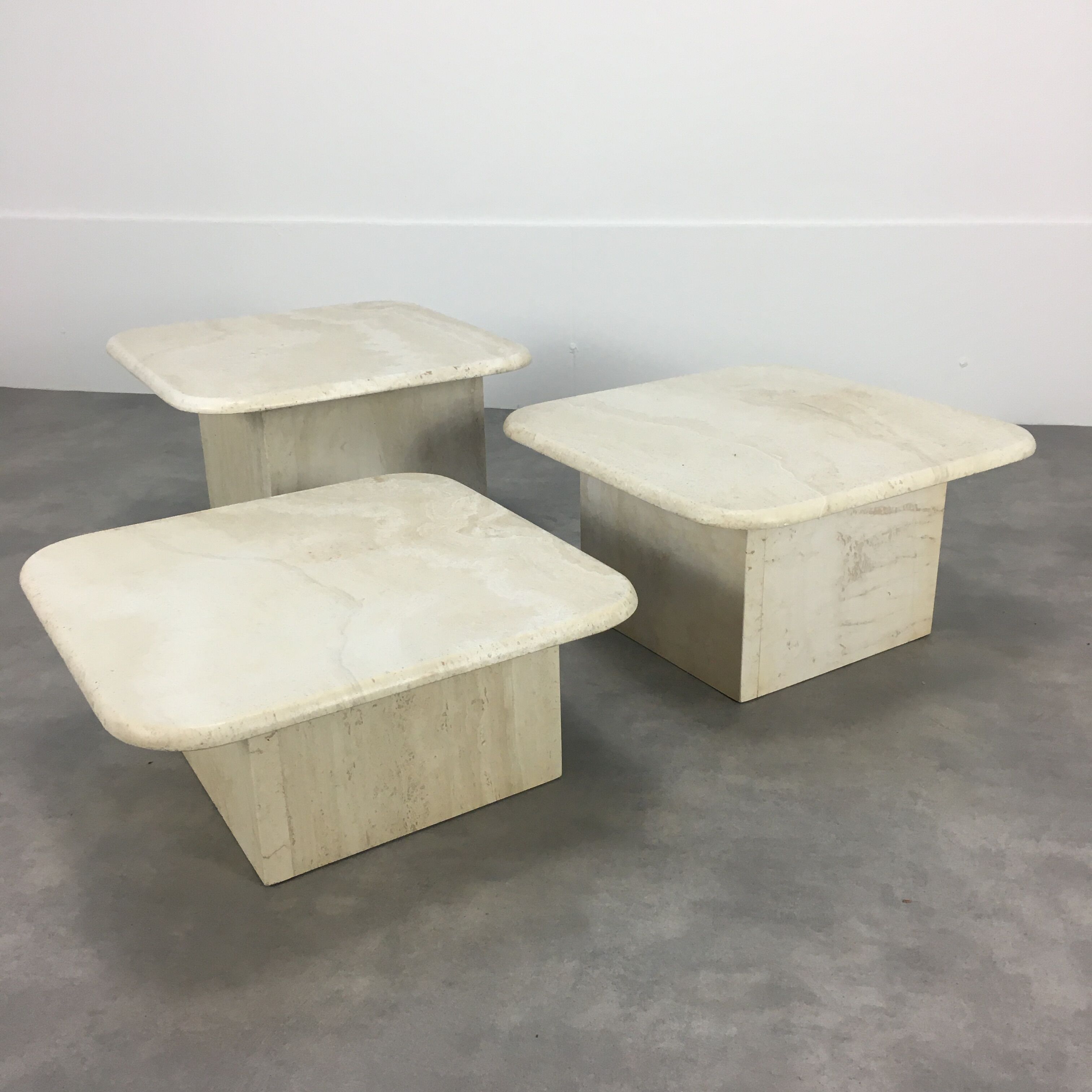 Three travertine trundle coffee tables