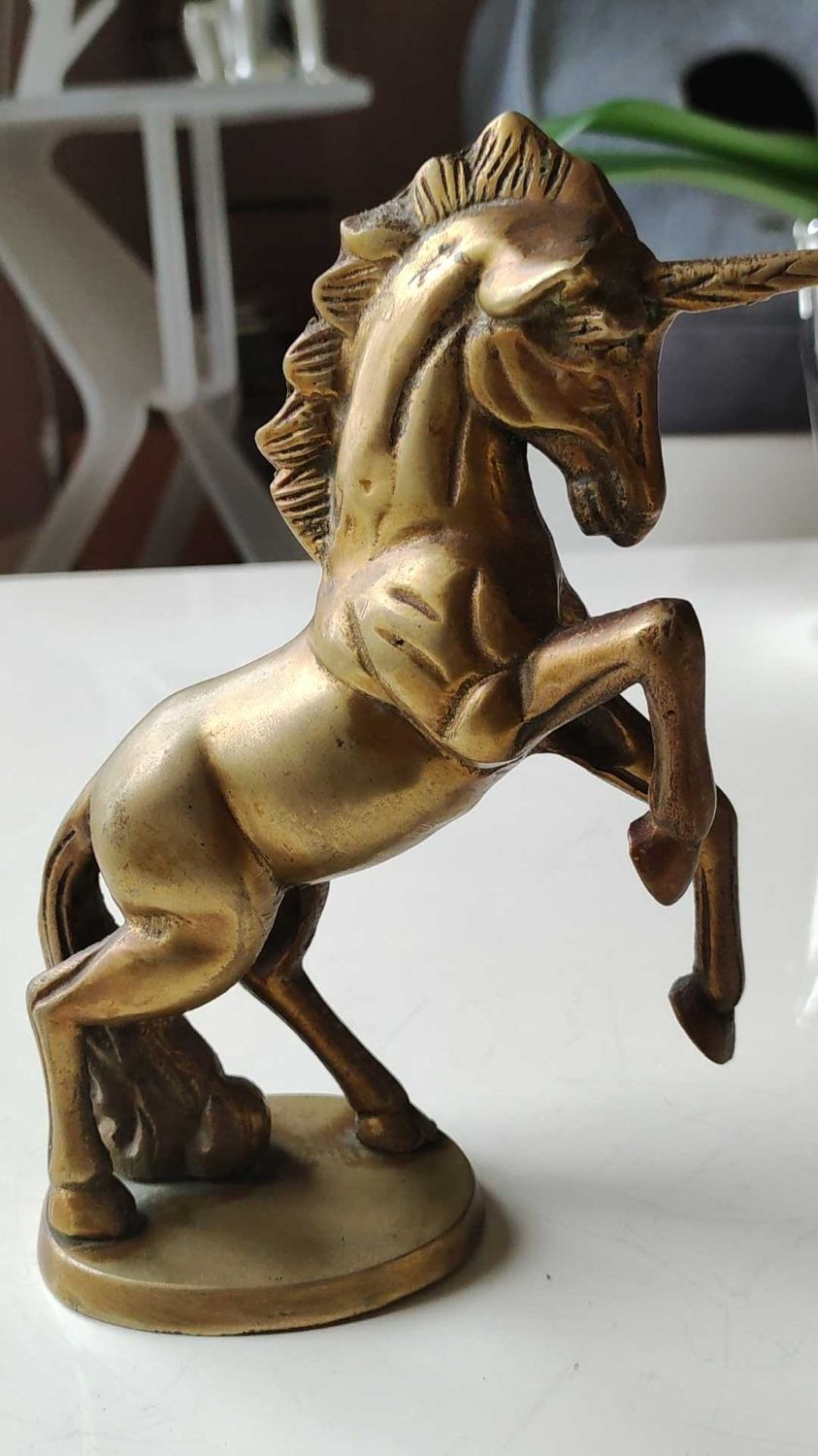 of greenhouse art deco bookends recancing unicorns. solid brass