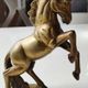 of greenhouse art deco bookends recancing unicorns. solid brass