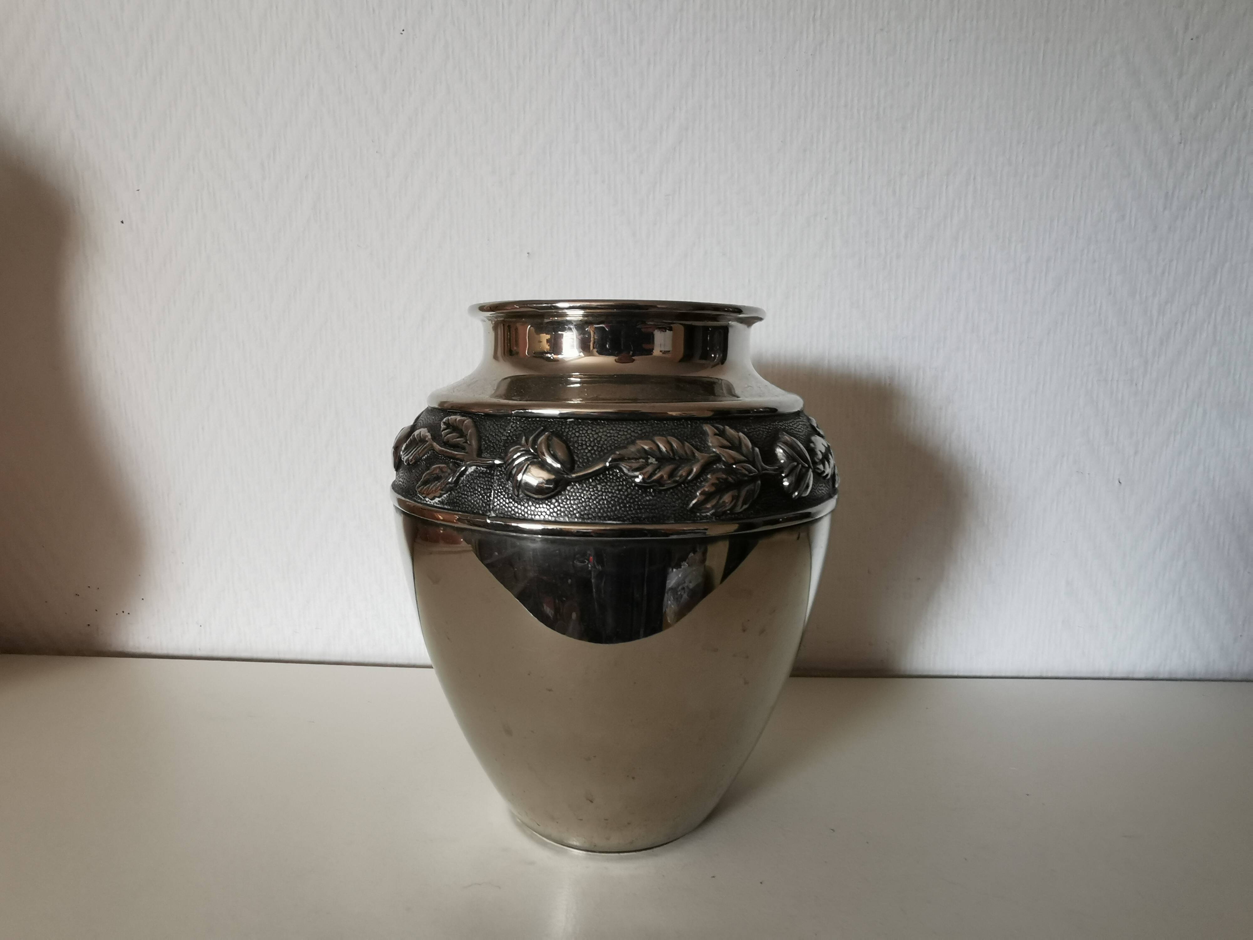 metal vase, flowers in relief