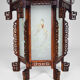 Asian wooden lantern carved with dragons and painted glass panels